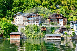 Amazing beautiful town of Hallstatt in sumemr season, Austria. Homes over the lake photo