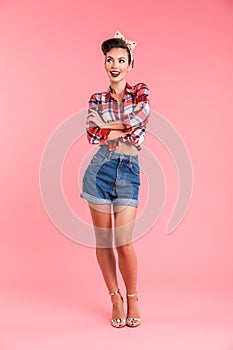 Amazing beautiful young pin-up woman looking aside at copyspase.