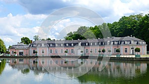 View of the beautiful pink building of Benrath Palace through a blooming spring tree, Dusseldorf, Germany photo