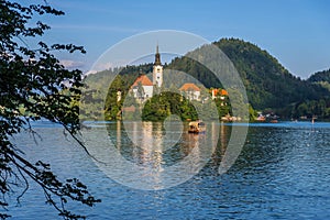 Amazing Bled Lake at sunset with church dedicated to the Assumption of Mary on a small island