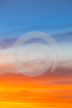 Amazing blue, orange and yellow colors sunset sky gradient vertical background