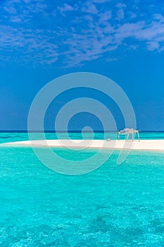 Amazing blue water in a desert island, blue sky day, wood hut photo