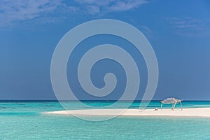 Amazing blue water in a desert island, blue sky day, wood hut photo