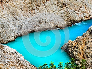 Amazing blue water of a secluded cove beach in Crete, Greece - Seitan Limania Beach