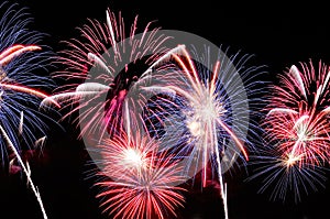 Amazing blue, white and red fireworks on dark background