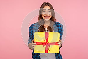 Amazing bonus, holiday present! Portrait of extremely happy girl in checkered shirt holding wrapped box photo