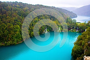 Amazing breathtaking landscape in Plitvice National Park, Croatia. Lakes and waterfalls in forest. Crystal clear azure blue water