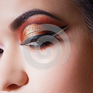 Amazing Bright eye makeup with a spectacular arrow. Brown and gold tones, colored eyeshadow