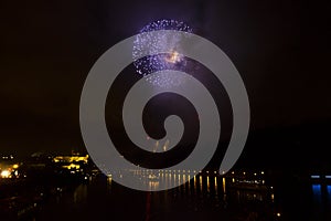 Amazing bright golden and purple firework celebration of the new year 2015 in Prague with the historic city in the background