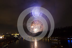 Amazing bright golden and purple firework celebration of the new year 2015 in Prague with the historic city in the background