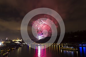 Amazing bright golden and purple firework celebration of the new year 2015 in Prague with the historic city in the background
