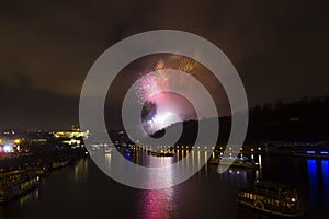 Amazing bright golden and purple firework celebration of the new year 2015 in Prague with the historic city in the background