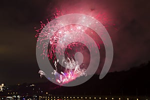 Amazing bright red and pink firework celebration of the new year 2015 in Prague with the historic city in the background