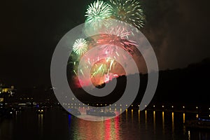 Amazing bright red,yellow,green firework celebration of the new year 2015 in Prague with the historic city in the background