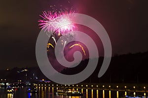 Amazing bright yellow and pink firework celebration of the new year 2015 in Prague with the historic city in the background