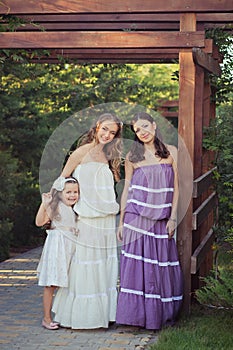 Amazing Brunette blond chestnut blue eyes sisters girls wearing stylish white purple dress enjoying vacation together spring sunny