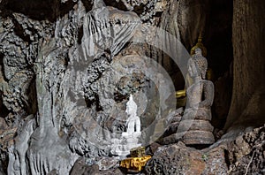 Amazing buddha statues in beautiful cave, holy natural buddhist sanctuary in Thailand