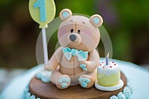 Amazing cake for boy`s first Birthday. Blue and white colors with Bear cub from sugar mastic