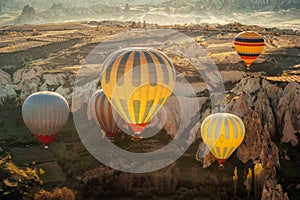 Amazing Cappadocia rocky landscape and balloons at sunrise, view of the valley and canyons