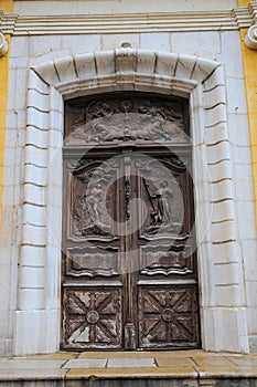 Amazing carved door of Church of the Immaculate Conception in Antibes, France photo