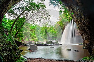 Amazing cave in deep forest with beautiful waterfalls background at Haew Suwat Waterfall in Khao Yai National Park, Thailand