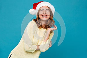 Amazing cheerful young lady wearing christmas hat