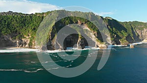 Amazing cliff with rocks and blue ocean in Bali. Aerial view