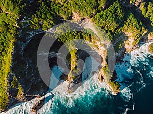 Amazing cliff, rocks and blue ocean with waves in Bali