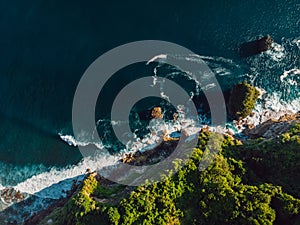 Amazing cliff, rocks and ocean with waves in Bali. Aerial view
