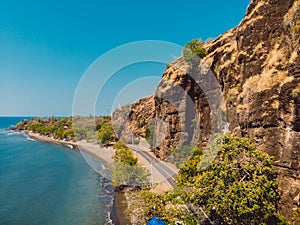 Amazing cliff with rocks, road and Bali sea at Northern Bali. Aerial view