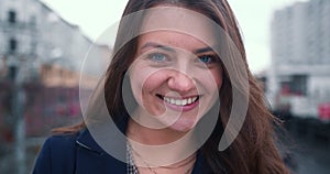 Amazing close-up portrait of beautiful happy 30-35 brunette Caucasian business woman smiling at camera slow motion.