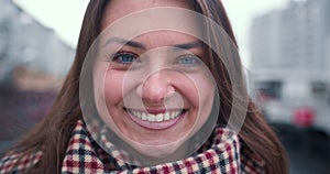 Amazing close-up portrait of excited beautiful happy 30-35 brunette business woman smiling at camera outside slow motion