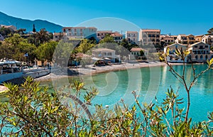 Amazing coastline with colorful houses under sunlight. Wonderful summer seascape with perfect blue sky of Ionian Sea