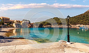 Amazing coastline with colorful houses under sunlight. Wonderful summer seascape with perfect blue sky of Ionian Sea
