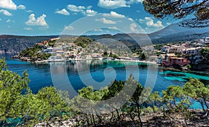 Amazing coastline with colorful houses under sunlight. Wonderful summer seascape with perfect blue sky of Ionian Sea