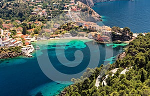 Amazing coastline with colorful houses under sunlight. Wonderful summer seascape with perfect blue sky of Ionian Sea. Assos