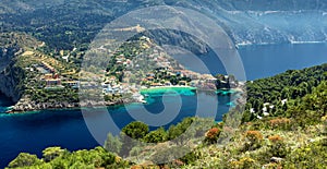 Amazing coastline with colorful houses under sunlight. Wonderful summer seascape with perfect blue sky of Ionian Sea. Assos