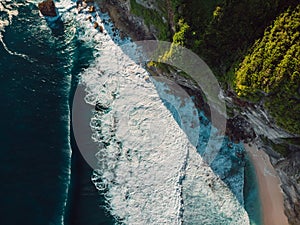 Amazing coastline with rocks and sea with waves in Bali. Aerial view