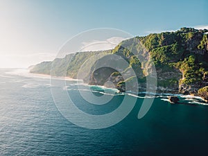 Amazing coastline with rocks, sunshine and sea in Bali. Aerial view