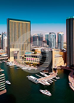 Amazing colorful dubai marina skyline with water canal during sunny day, Dubai, United Arab Emirates.