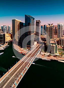 Amazing colorful dubai marina skyline with water canal during sunny day, Dubai, United Arab Emirates.