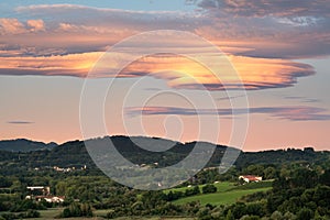 Amazing colorful lenticular clouds over village in countryside. Irun, Basque Country, Spain.