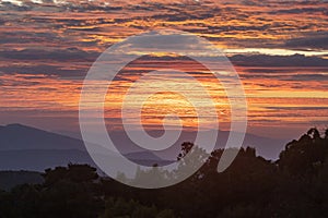 Amazing colorful sunrise sky over the rainforest mountains at Ob Luang natinoal park, Chiangmai, Thailand