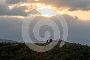 Amazing colorful sunset in Tuscany. Picturesque agritourism and typical rural landscape in Tuscany, Italy, Europe.