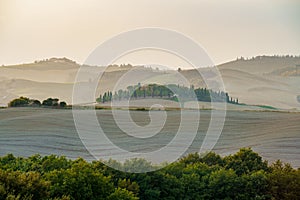 Amazing colorful sunset in Tuscany. Picturesque agritourism and typical rural landscape in Tuscany, Italy, Europe.