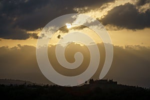 Amazing colorful sunset in Tuscany. Picturesque agritourism and typical rural landscape in Tuscany, Italy, Europe.