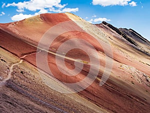 Amazing colors of the Red Valley (valle rojo) with stunning path leading to the top of the mountain, Cusco region, Peru