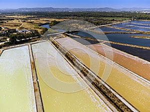 Amazing colors of sea salt ponds shortly before salt harvest in Portugal photo