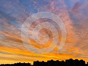 Amazing colours, sky in the sunset with house silhouettes