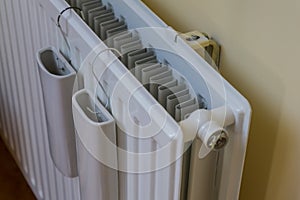 Amazing composition of indoor wall heater, warmer or radiator. With two white water reservoir, tank or holders on it. Attatched to photo